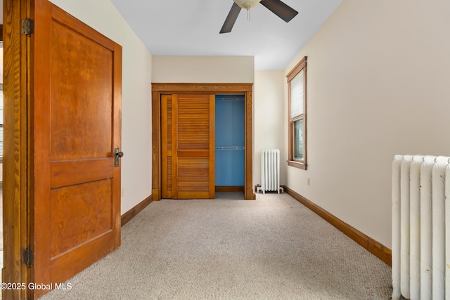 bedroom with baseboards, carpet floors, and radiator heating unit