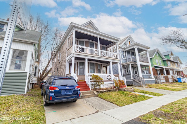 multi unit property featuring a balcony and a porch
