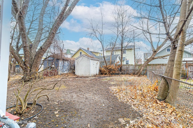 view of yard featuring a fenced backyard, an outbuilding, and a storage unit