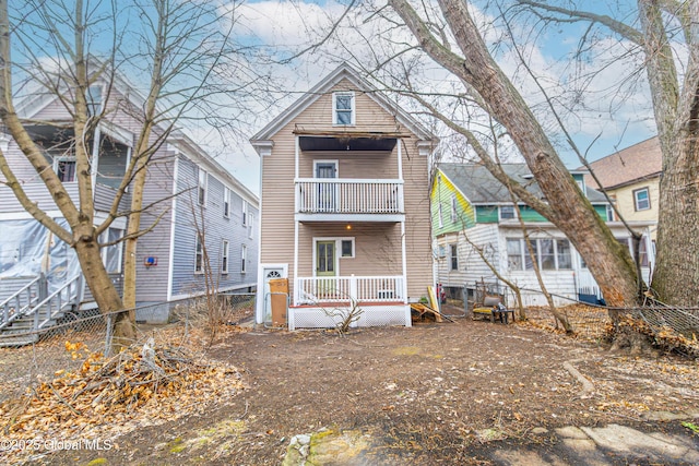 rear view of property with a balcony