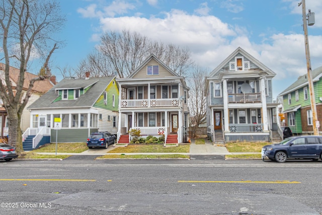 view of front of property with a balcony and covered porch