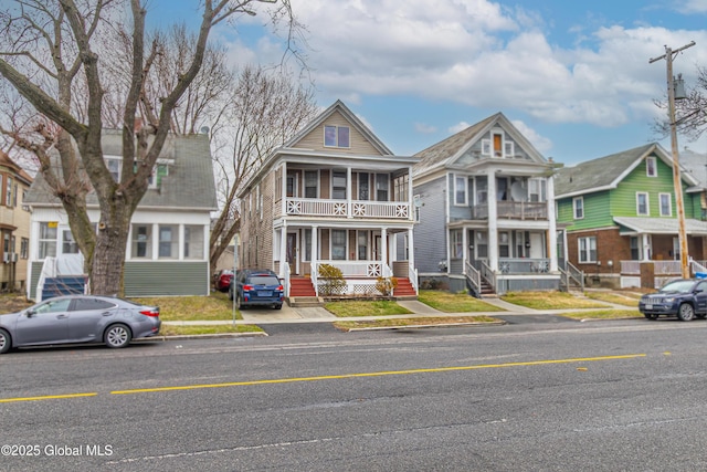 view of front of home with a residential view and a balcony