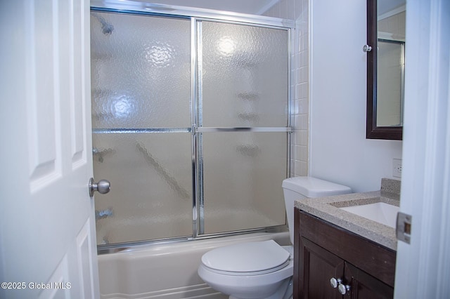 full bath featuring enclosed tub / shower combo, vanity, and toilet