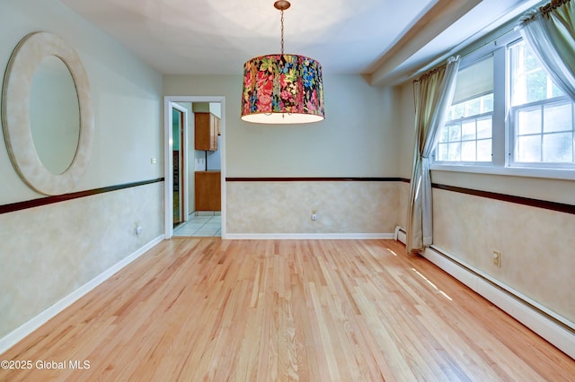 15 Garrison Ln, Clifton Park, NY 12019 - empty room featuring a baseboard radiator and wood finished floors