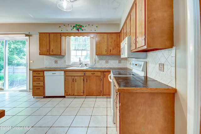 15 Garrison Ln, Clifton Park, NY 12019 - kitchen featuring white appliances, backsplash, brown cabinets, and tile counters