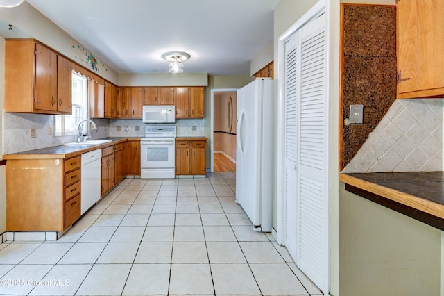 15 Garrison Ln, Clifton Park, NY 12019 - kitchen with white appliances, brown cabinetry, backsplash, and light tile patterned flooring