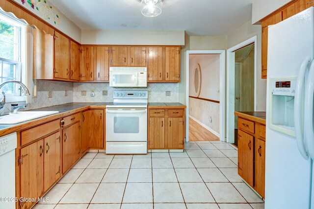 15 Garrison Ln, Clifton Park, NY 12019 - kitchen with white appliances, tasteful backsplash, brown cabinetry, light tile patterned flooring, and light countertops