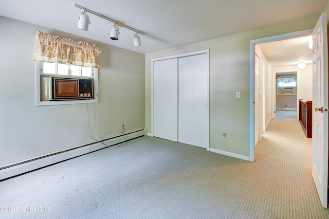 15 Garrison Ln, Clifton Park, NY 12019 - unfurnished bedroom with a baseboard radiator, carpet flooring, a closet, rail lighting, and baseboard heating