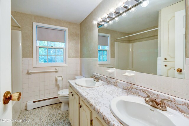 15 Garrison Ln, Clifton Park, NY 12019 - full bathroom featuring a baseboard heating unit, a shower, plenty of natural light, tile walls, and wainscoting