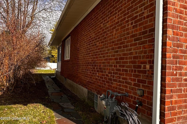 view of home's exterior featuring brick siding and crawl space