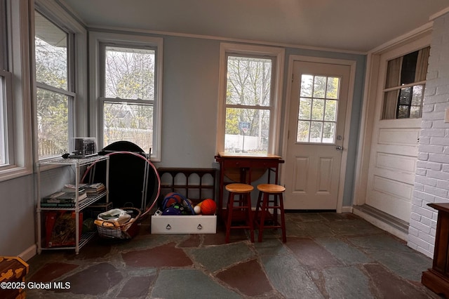 entryway featuring baseboards and stone tile floors