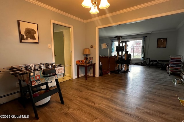 dining space featuring an inviting chandelier, crown molding, and wood finished floors