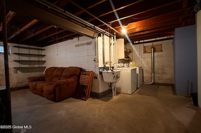 unfinished below grade area with washer and dryer and a sink