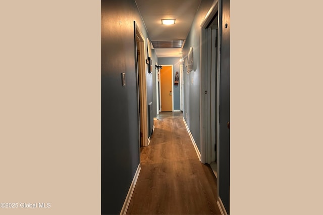 hallway with baseboards and dark wood-style flooring