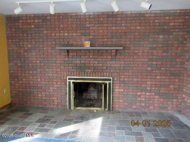 545 Stage Rd, Cambridge, NY 12028 - interior details featuring a brick fireplace and rail lighting