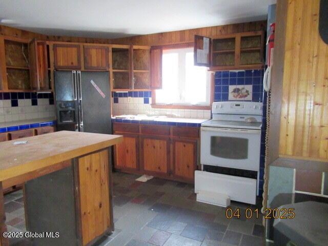 545 Stage Rd, Cambridge, NY 12028 - kitchen featuring tile counters, white electric stove, tasteful backsplash, open shelves, and black fridge
