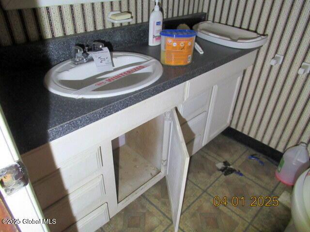 545 Stage Rd, Cambridge, NY 12028 - bathroom featuring a sink, wallpapered walls, and tile patterned flooring
