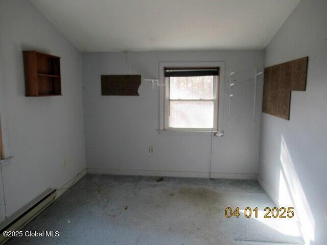 545 Stage Rd, Cambridge, NY 12028 - empty room with carpet floors, baseboards, vaulted ceiling, and a baseboard heating unit