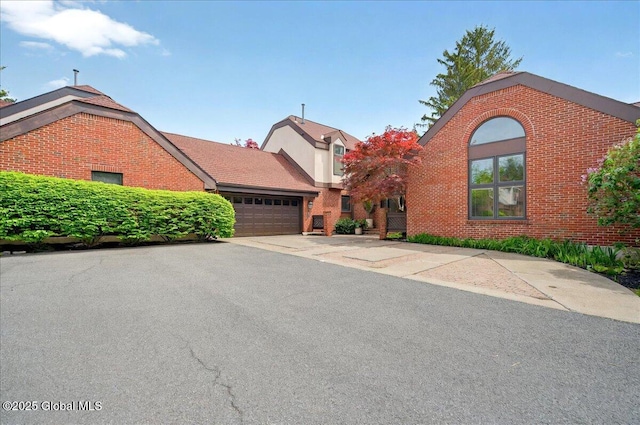 101 E Krumkill Rd, Albany, NY 12208 - view of front of property featuring brick siding, an attached garage, and driveway
