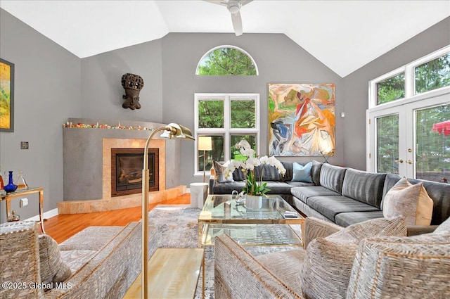 101 E Krumkill Rd, Albany, NY 12208 - living area featuring a fireplace, wood finished floors, healthy amount of natural light, a ceiling fan, and high vaulted ceiling