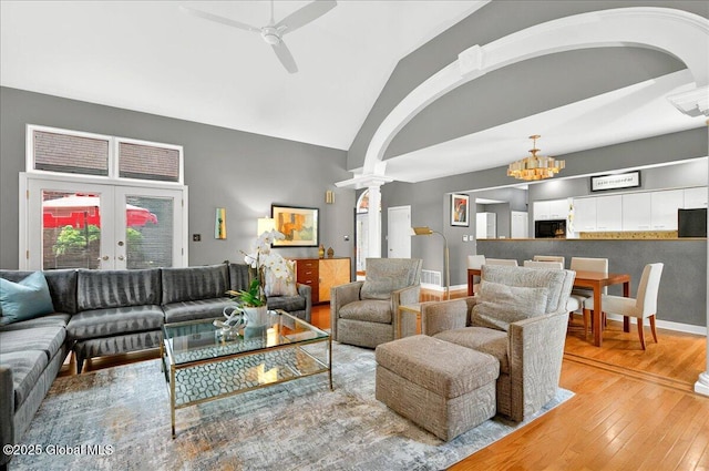 101 E Krumkill Rd, Albany, NY 12208 - living area featuring hardwood / wood-style floors, decorative columns, vaulted ceiling, a ceiling fan, and arched walkways