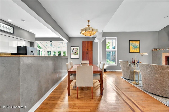 101 E Krumkill Rd, Albany, NY 12208 - dining area with wood finished floors, baseboards, a chandelier, and recessed lighting