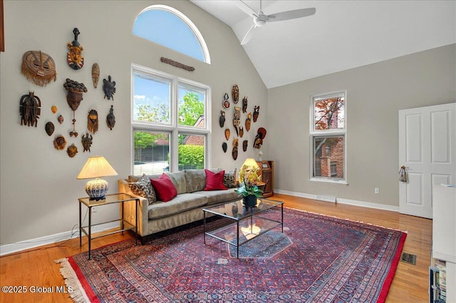 101 E Krumkill Rd, Albany, NY 12208 - living room featuring high vaulted ceiling, a ceiling fan, wood finished floors, and baseboards
