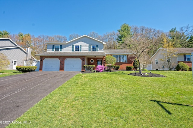 view of front of house featuring brick siding, a garage, driveway, and a front yard