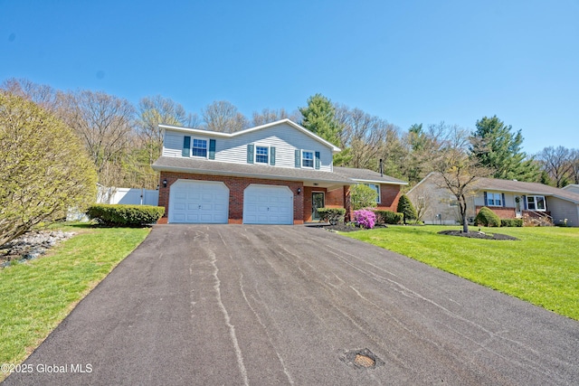 traditional-style house with aphalt driveway, a garage, brick siding, fence, and a front lawn