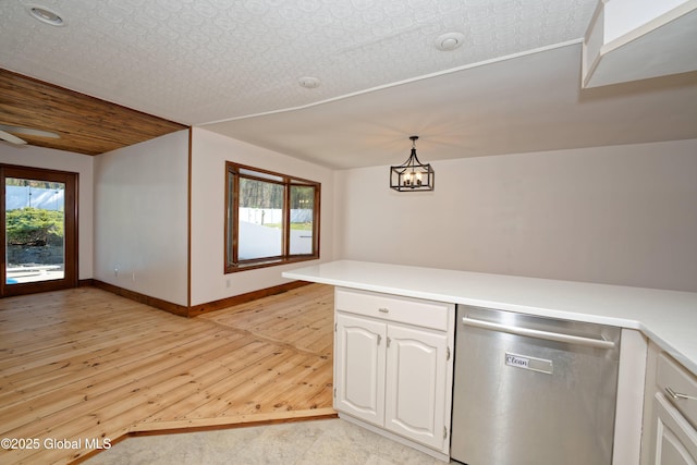 kitchen featuring stainless steel dishwasher, light countertops, white cabinets, and light wood-type flooring