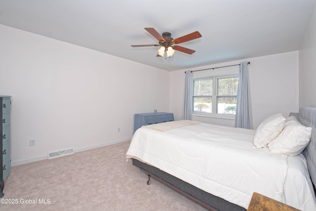 bedroom with a ceiling fan, baseboards, visible vents, and carpet
