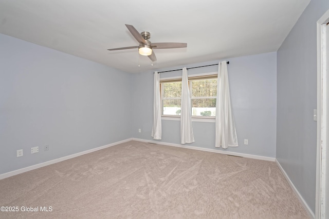 unfurnished room with baseboards, a ceiling fan, and carpet