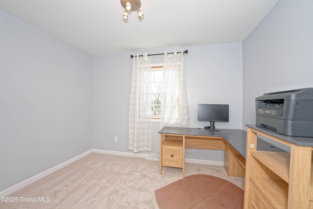 home office with baseboards and light carpet