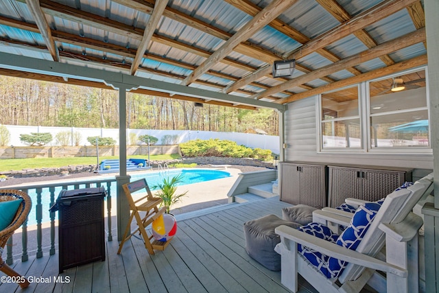 wooden terrace featuring a fenced in pool and a fenced backyard