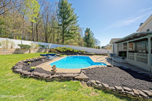 view of swimming pool featuring a yard, a patio, a fenced in pool, and a fenced backyard