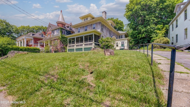 121 Guy Park Ave, Amsterdam, NY 12010 - rear view of property featuring a sunroom, a chimney, and a yard