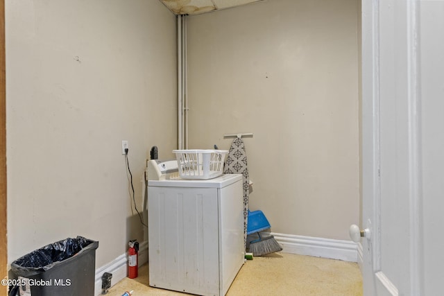 laundry room featuring washer / dryer, baseboards, and carpet flooring