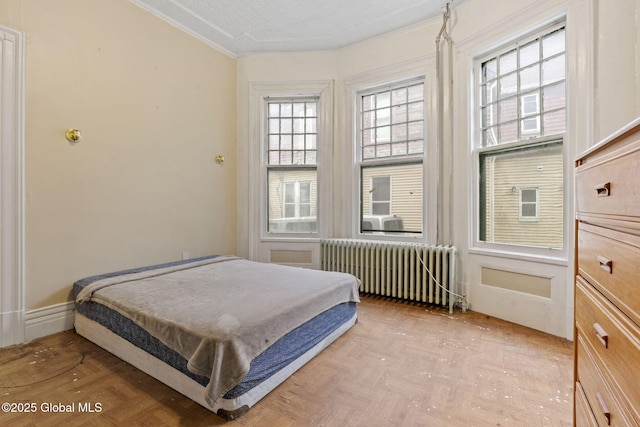 bedroom with radiator and ornamental molding