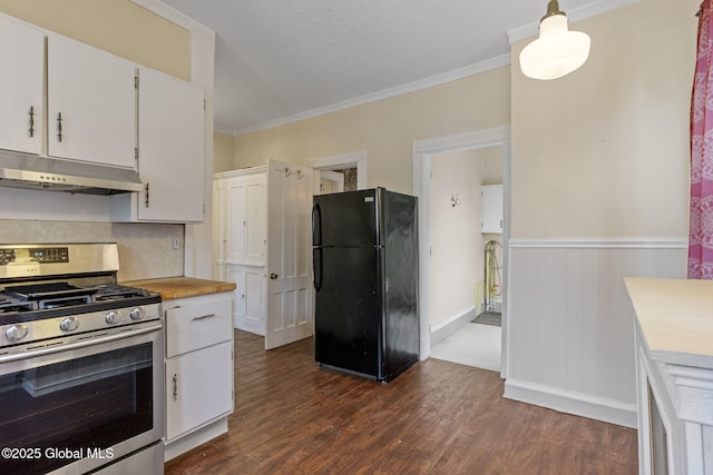 kitchen with freestanding refrigerator, stainless steel gas stove, under cabinet range hood, light countertops, and white cabinets