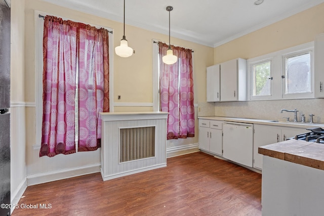 kitchen with dishwasher, crown molding, dark wood-style flooring, a sink, and white cabinetry