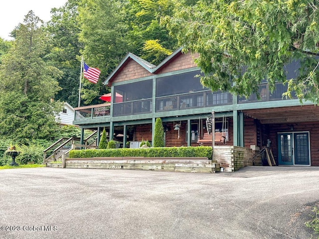 9667 Lake Shore Dr, Hague, NY 12836 - view of front of house with a sunroom, stairway, and french doors