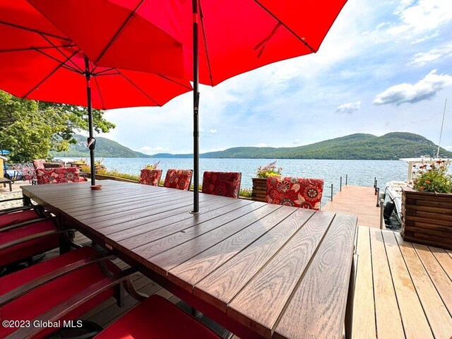 9667 Lake Shore Dr, Hague, NY 12836 - dock area featuring a water and mountain view and outdoor dining space