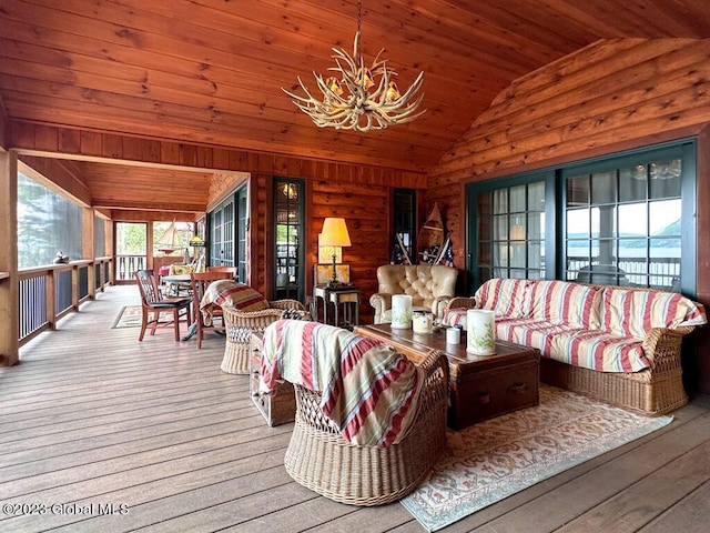 9667 Lake Shore Dr, Hague, NY 12836 - living room featuring vaulted ceiling, wood walls, wood ceiling, wood finished floors, and a chandelier