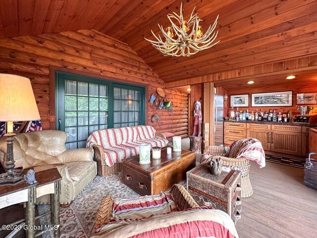 9667 Lake Shore Dr, Hague, NY 12836 - living area featuring lofted ceiling, wood ceiling, a chandelier, and rustic walls