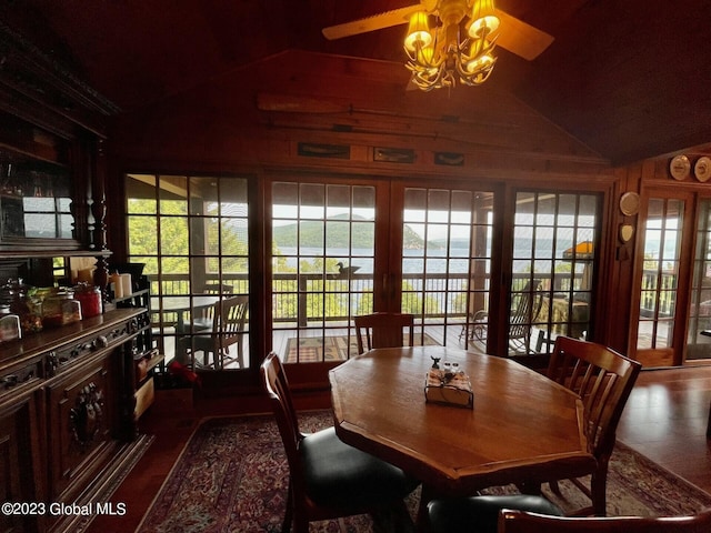 9667 Lake Shore Dr, Hague, NY 12836 - dining room featuring lofted ceiling, wood walls, and a ceiling fan