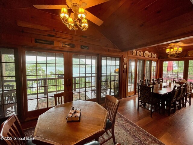 9667 Lake Shore Dr, Hague, NY 12836 - dining room featuring a chandelier, vaulted ceiling, wood finished floors, a ceiling fan, and wood ceiling
