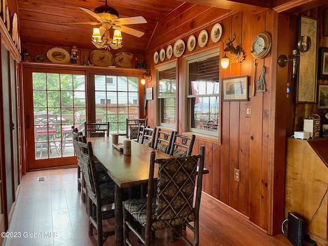 9667 Lake Shore Dr, Hague, NY 12836 - dining area featuring lofted ceiling, wooden walls, ceiling fan, wood ceiling, and wood finished floors
