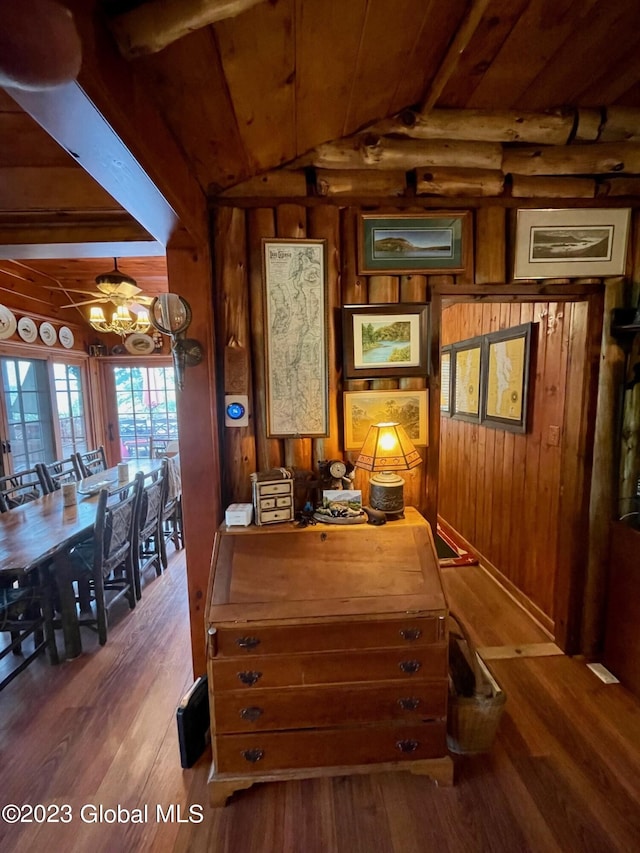 9667 Lake Shore Dr, Hague, NY 12836 - dining space with wooden ceiling, wood walls, hardwood / wood-style floors, and a chandelier