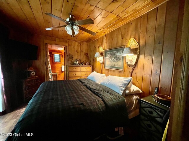 9667 Lake Shore Dr, Hague, NY 12836 - bedroom featuring wooden ceiling, wood walls, light wood-style flooring, and vaulted ceiling