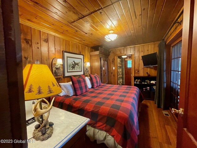 9667 Lake Shore Dr, Hague, NY 12836 - bedroom featuring wood walls, wood ceiling, and wood finished floors